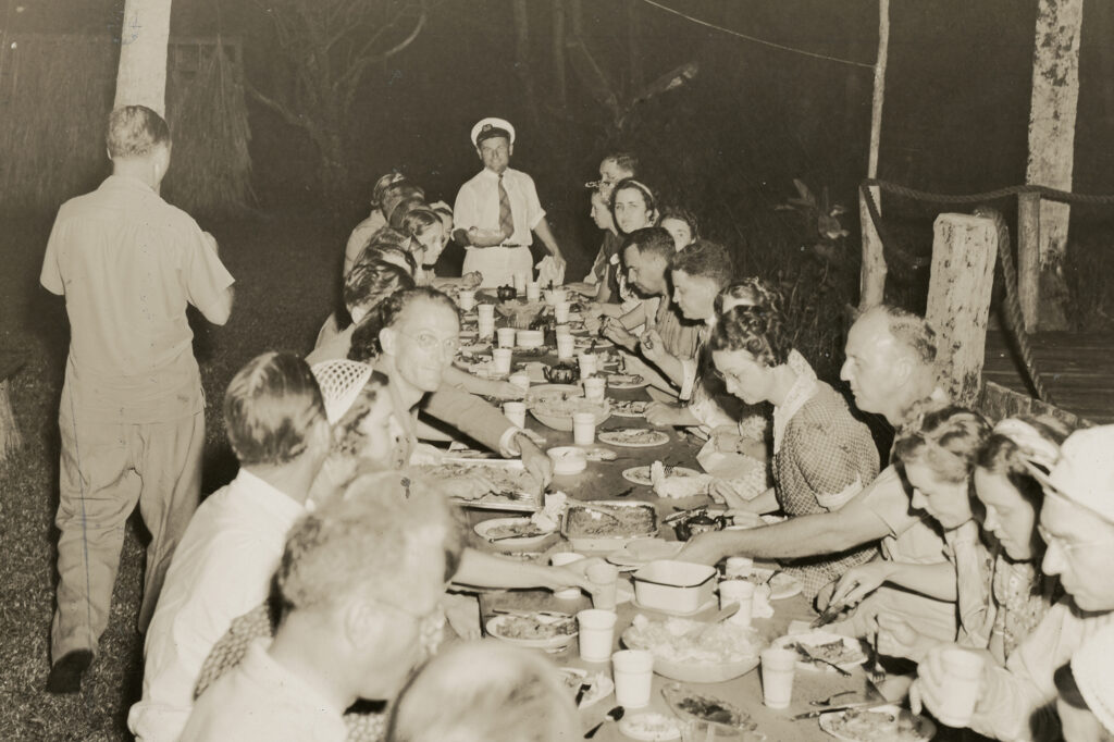 Historic photo of guests enjoying all you can eat BBQ dinner on Jungle Queen Island