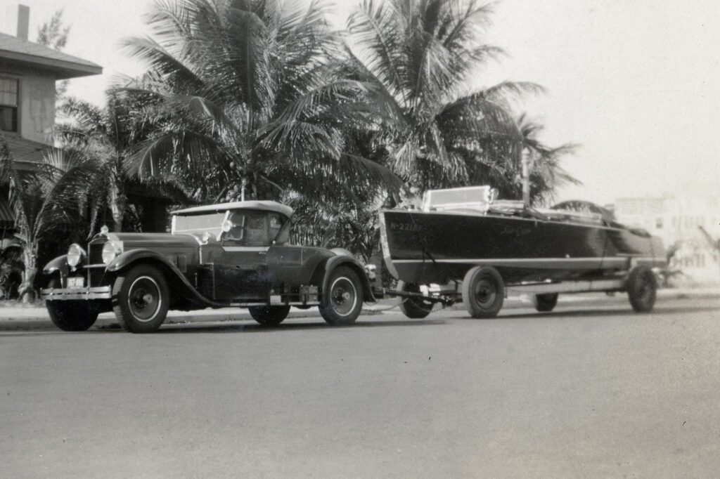 Historic photos of car puling a yacht on a trailer