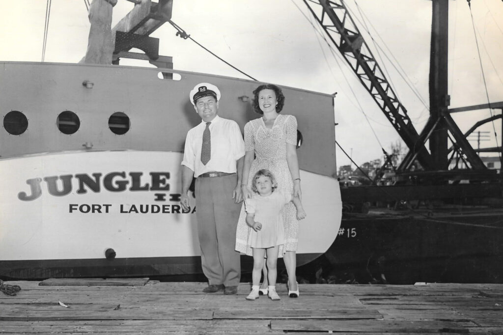 Historic photo of captain and family in front of Jungle Queen